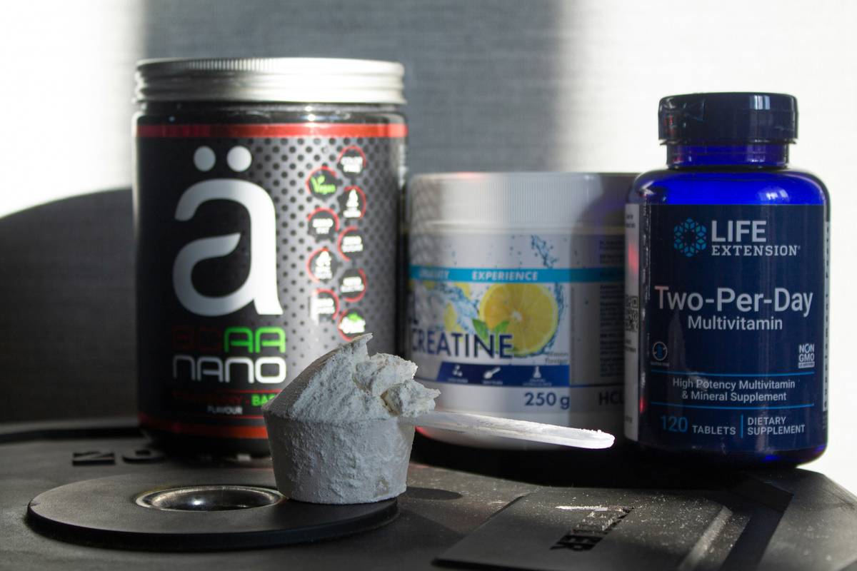 Woman reviewing pre menopause supplements for women on kitchen counter with symptom journal