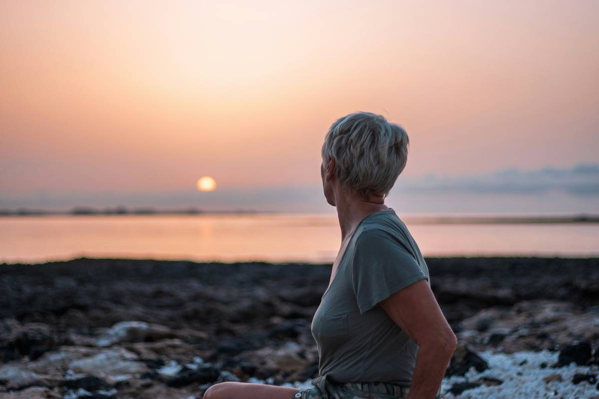 Woman taking new phase menopause supplement with morning tea