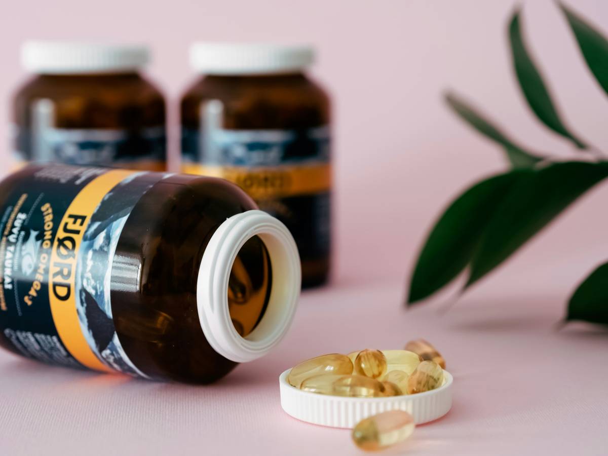 Pre menopause supplements for women arranged with hormone receptor diagram on desk