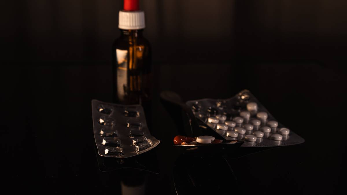 woman peacefully sleeping with bottle of menopause supplements for sleep on nightstand