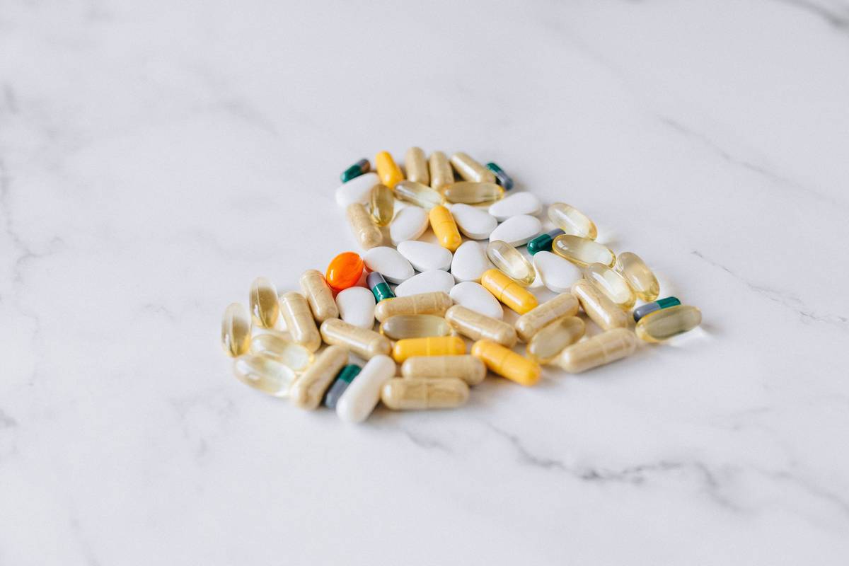 woman reviewing supplements for the menopause on kitchen counter
