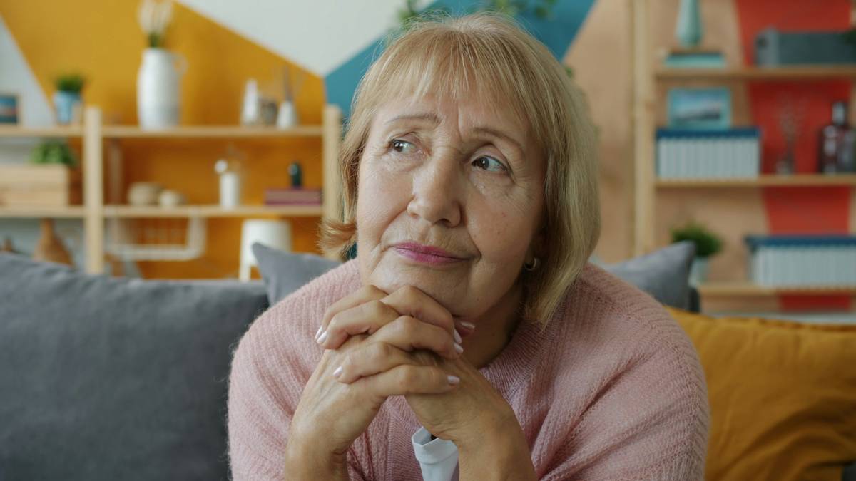 hot flash remedy menopause supplement treatment: woman checking supplement label with magnifying glass